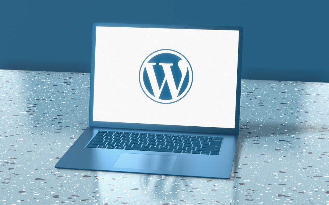 Blue laptop displaying the WordPress logo representing professional maintenance and security support.
